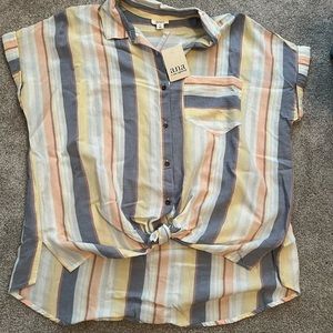 Women’s short sleeve button up. Knotted at bottom.